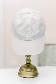 White Baseball Cap with Gray Cake Bake Shop Logo